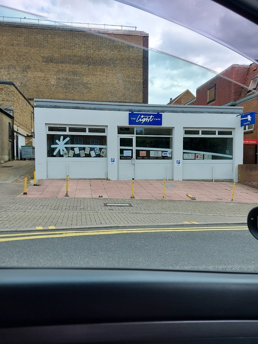 The Light Cafe's single-storey white shopfront on Ethelbert Road, Bromley, with its blue sign above three windows